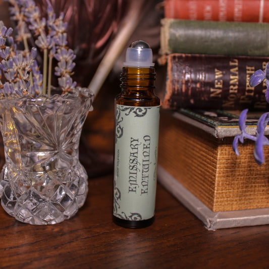 Roll-on bottle with lavender flowers and books in the background