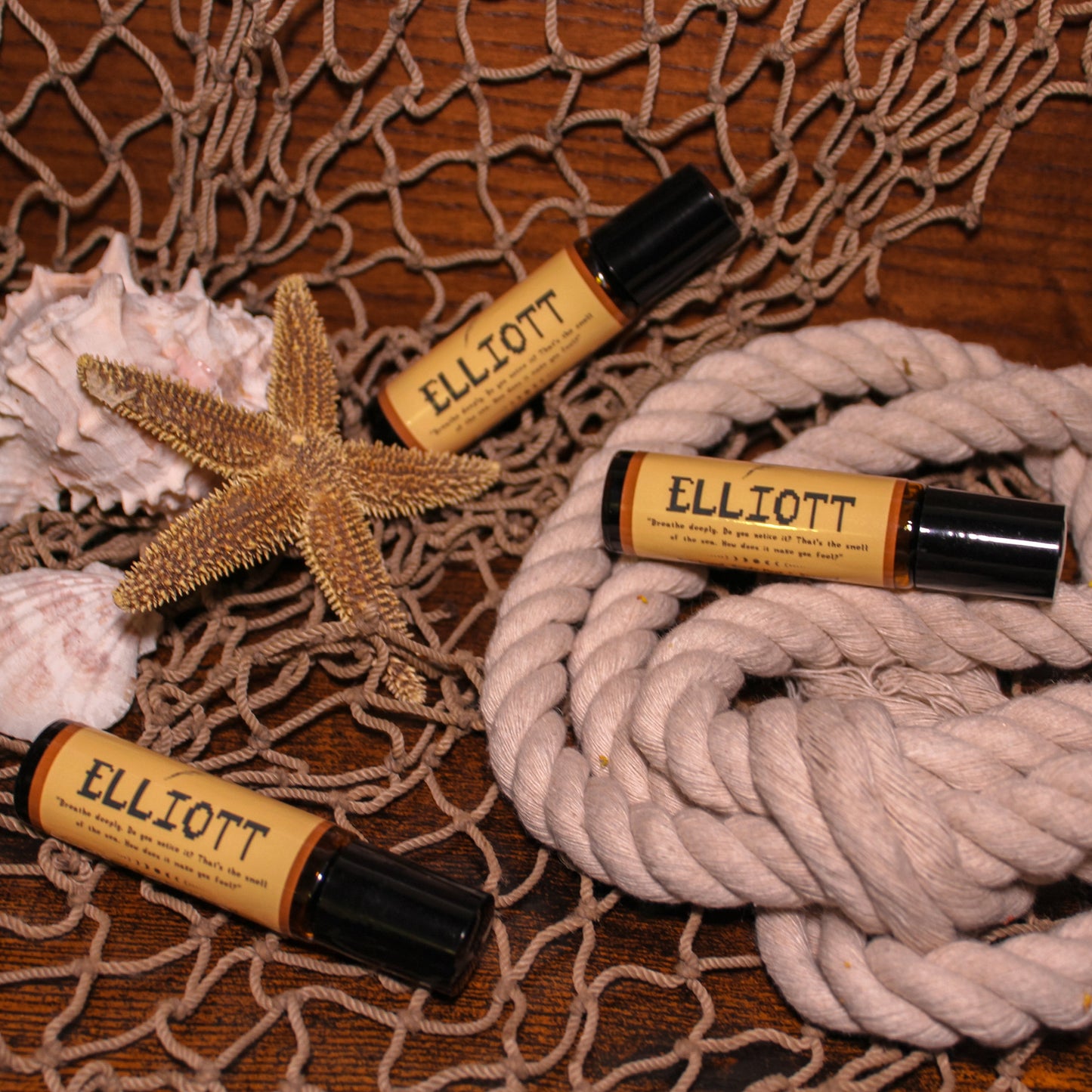 Three Elliott roller balls on a textured surface with rope and starfish